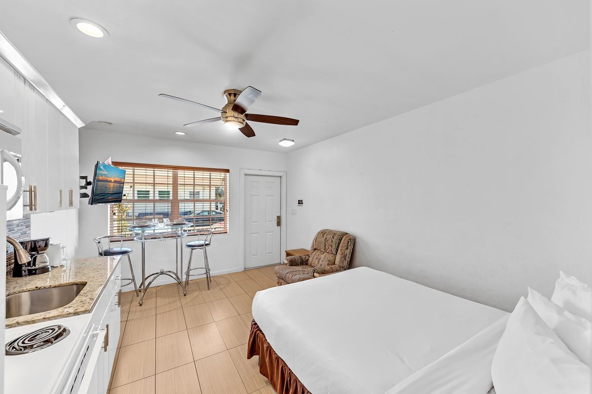 Another room, bed and kitchen