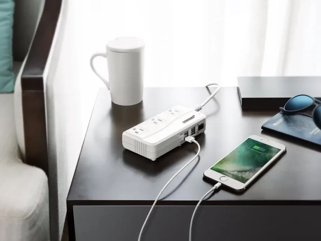 Packing guide - Iphone charger and the universal power adapter on the table 